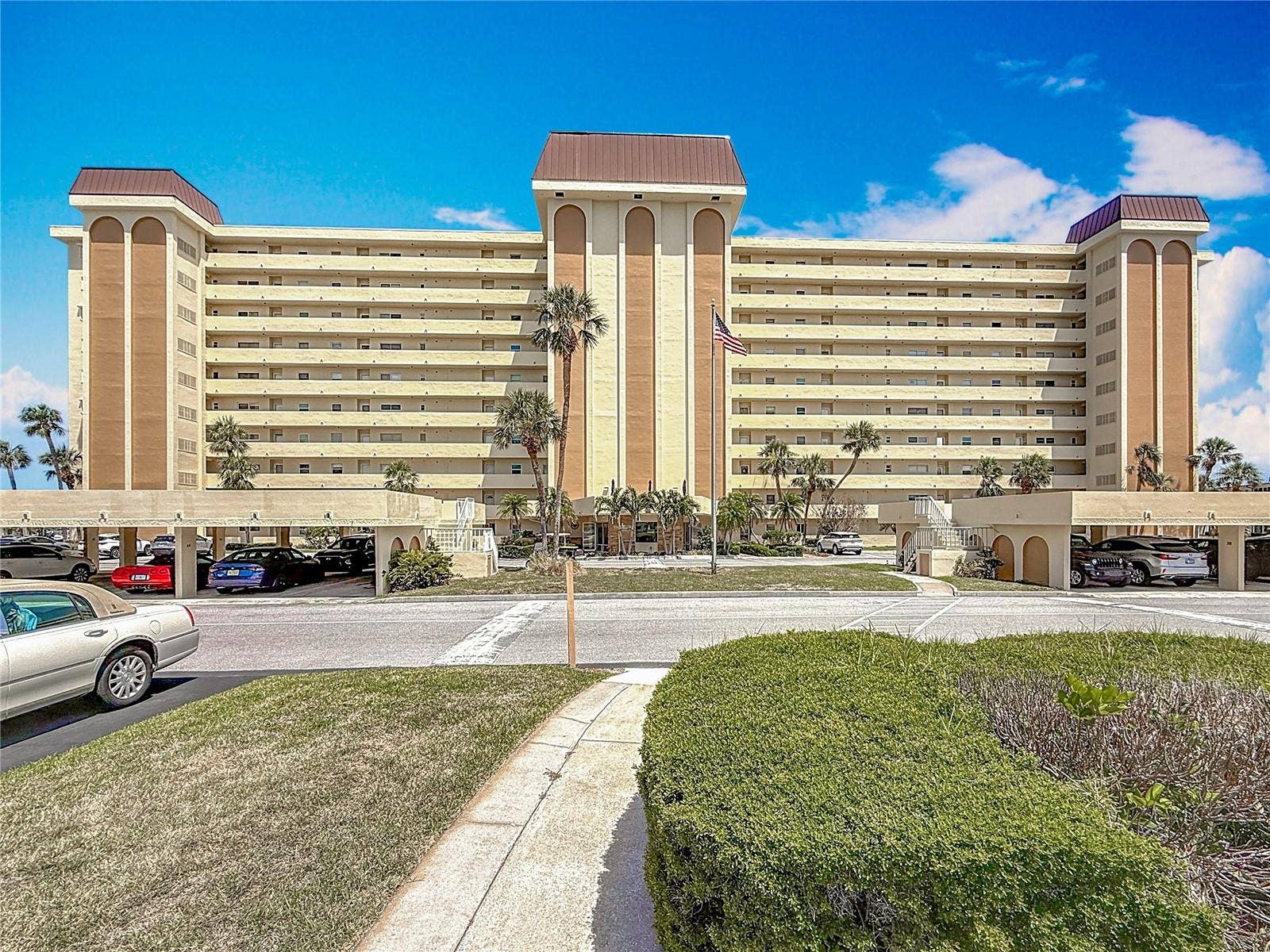 4725 COVE CIRCLE, #908, St Petersburg, FL 33708 This shows the Columbia building up close and the carports. This unit comes with Carport #29 which is very close to the entrance to the elevator and building.