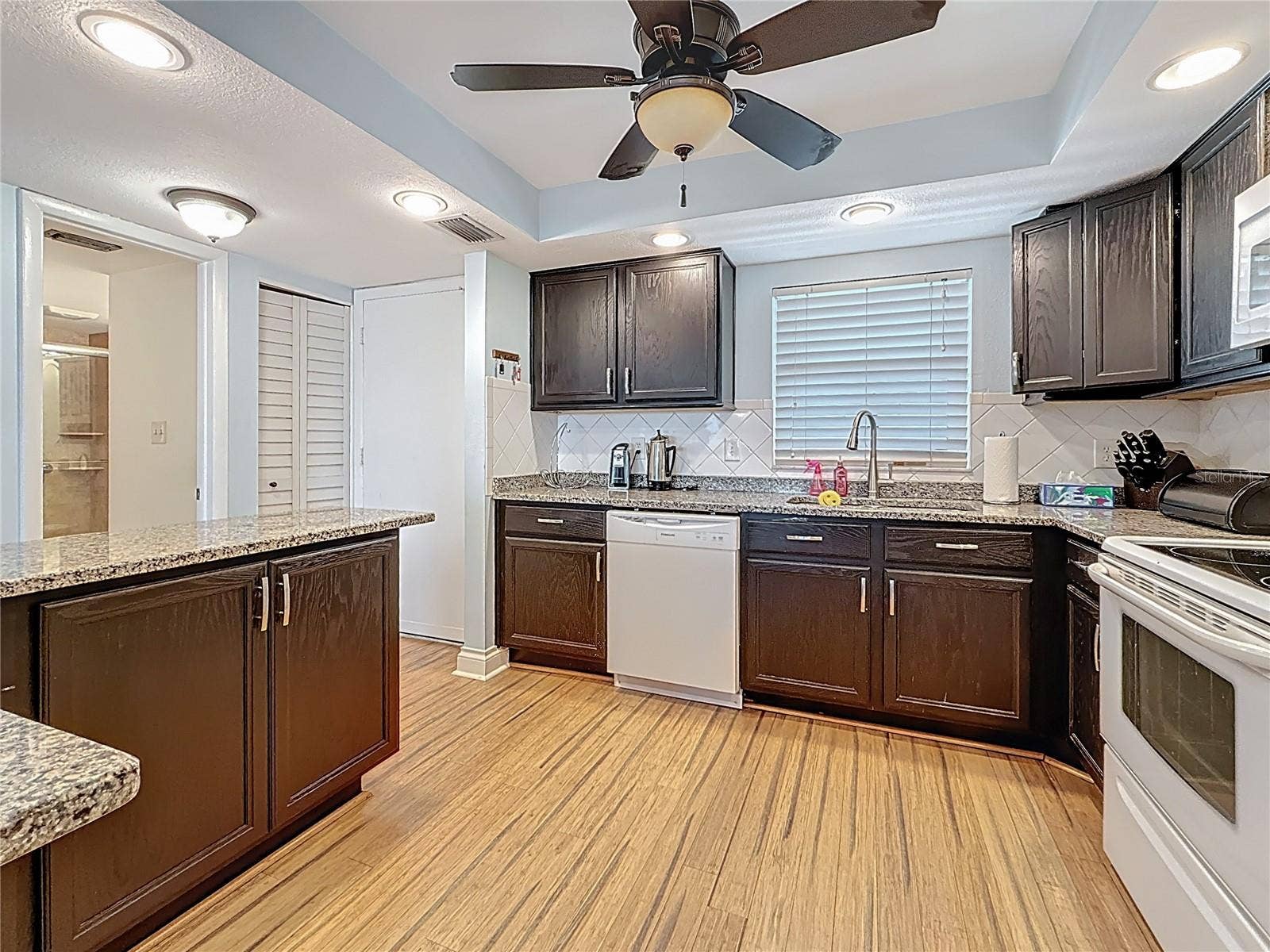 4725 COVE CIRCLE, #908, St Petersburg, FL 33708 This view shows the open kitchen plan and the extra cabinet space and counter space that this kitchen has