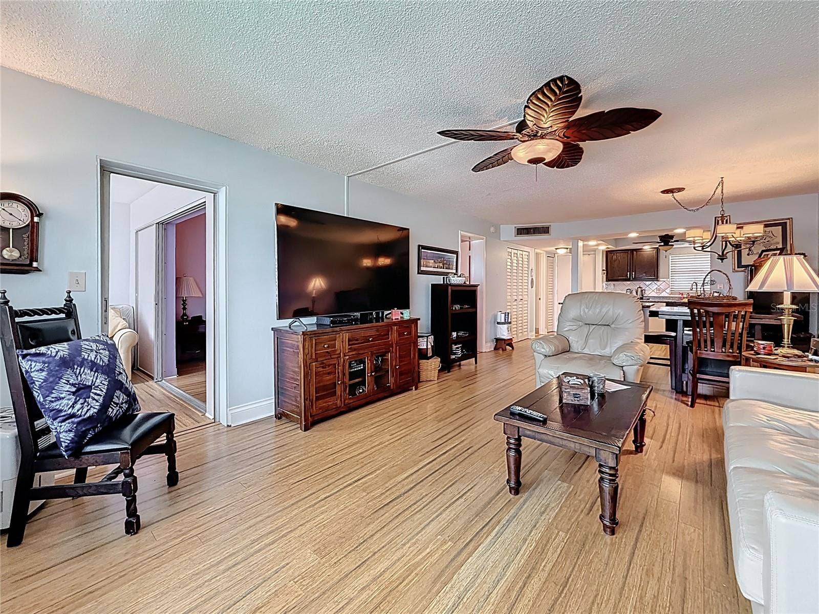 4725 COVE CIRCLE, #908, St Petersburg, FL 33708 This pictures shows the living space looking back from the back of the condo. This living space can be set up any way you would like. Notice the doorway that leads to the Florida room.