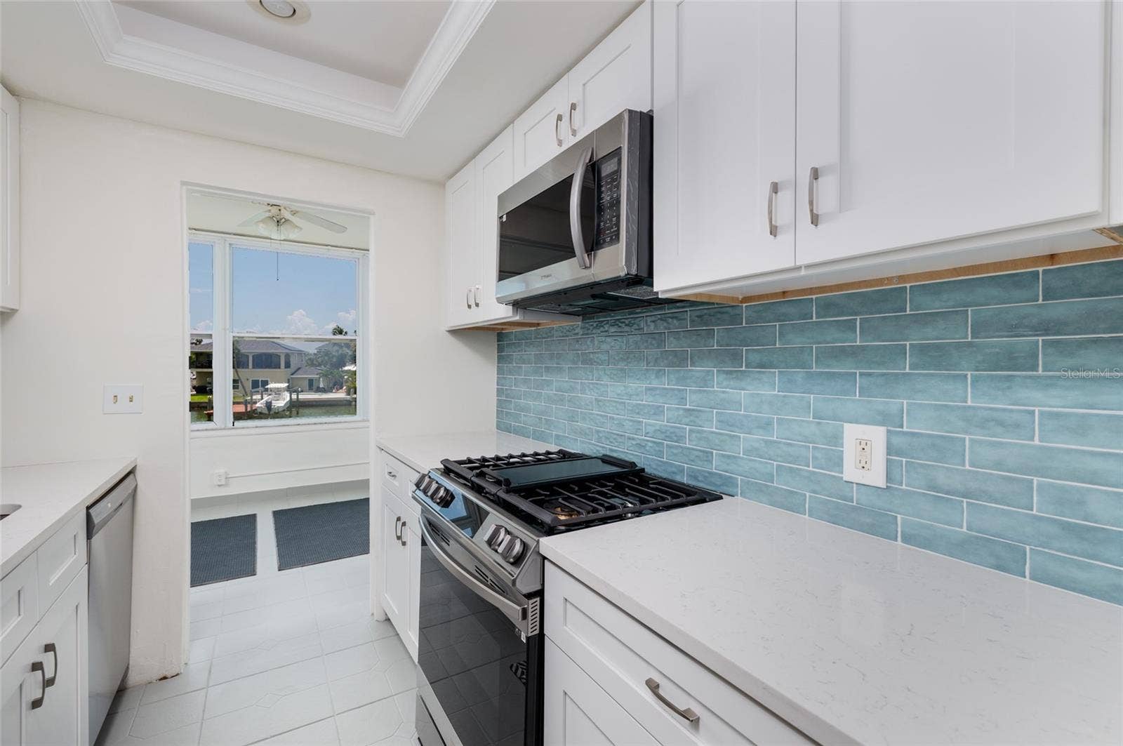 1893 SHORE DRIVE S, #209, South Pasadena, FL 33707 New shaker cabinets w/self closing doors & drawers. Doorway to Florida Room.