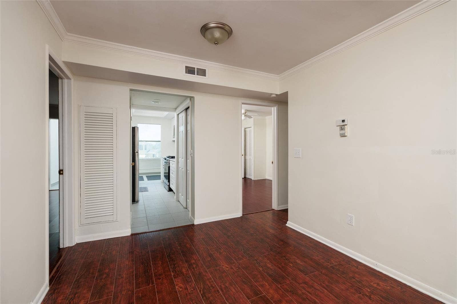 1893 SHORE DRIVE S, #209, South Pasadena, FL 33707 Dining Area w/Crown Molding. 9'x 8'. Kitchen in middle & bedrooms on both sides. Bathroom on right side of dining area.