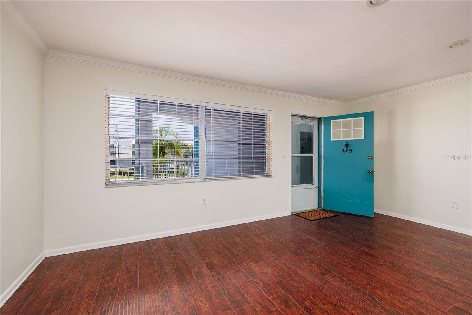 1893 SHORE DRIVE S, #209, South Pasadena, FL 33707 Large living room windows with tropical views. Screened storm door.