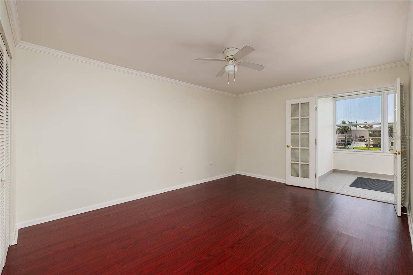 1893 SHORE DRIVE S, #209, South Pasadena, FL 33707 Primary Bedroom: Can accommodate a King size bed. Water views. French doors to Florida room. 11' x 15'. Crown Molding.