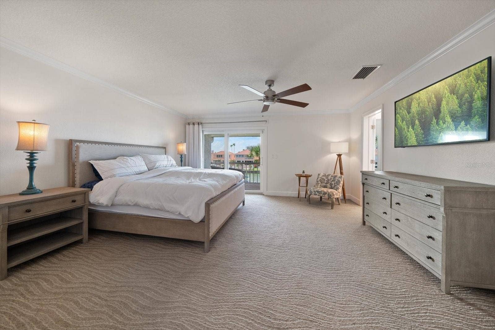 119 MARINA DEL REY COURT, Clearwater Beach, FL 33767 Primary suite is grand and offers private access to a balcony overlooking the canal.