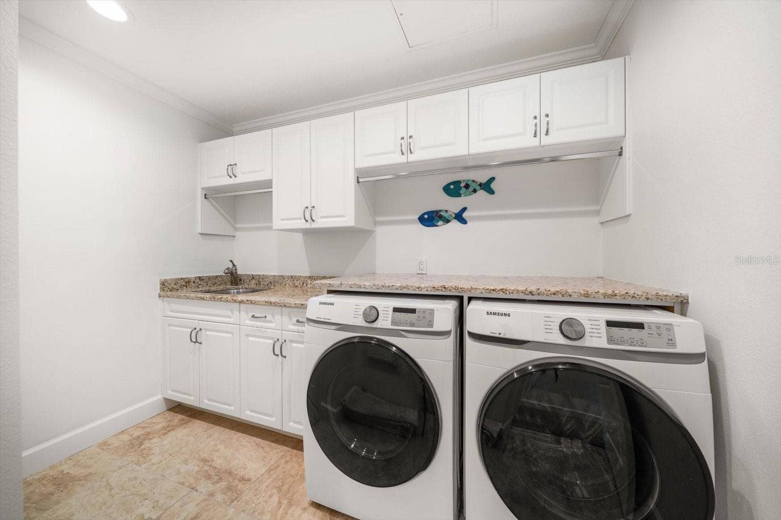 119 MARINA DEL REY COURT, Clearwater Beach, FL 33767 Laundry room with separate utility sink and storage.
