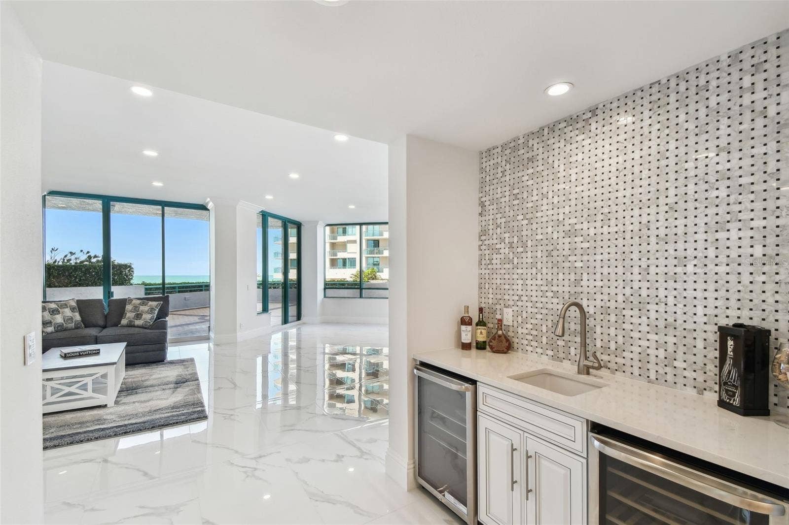 1560 GULF BOULEVARD, #306, Clearwater Beach, FL 33767 Wet Bar with wine refrigerators near living room entrance