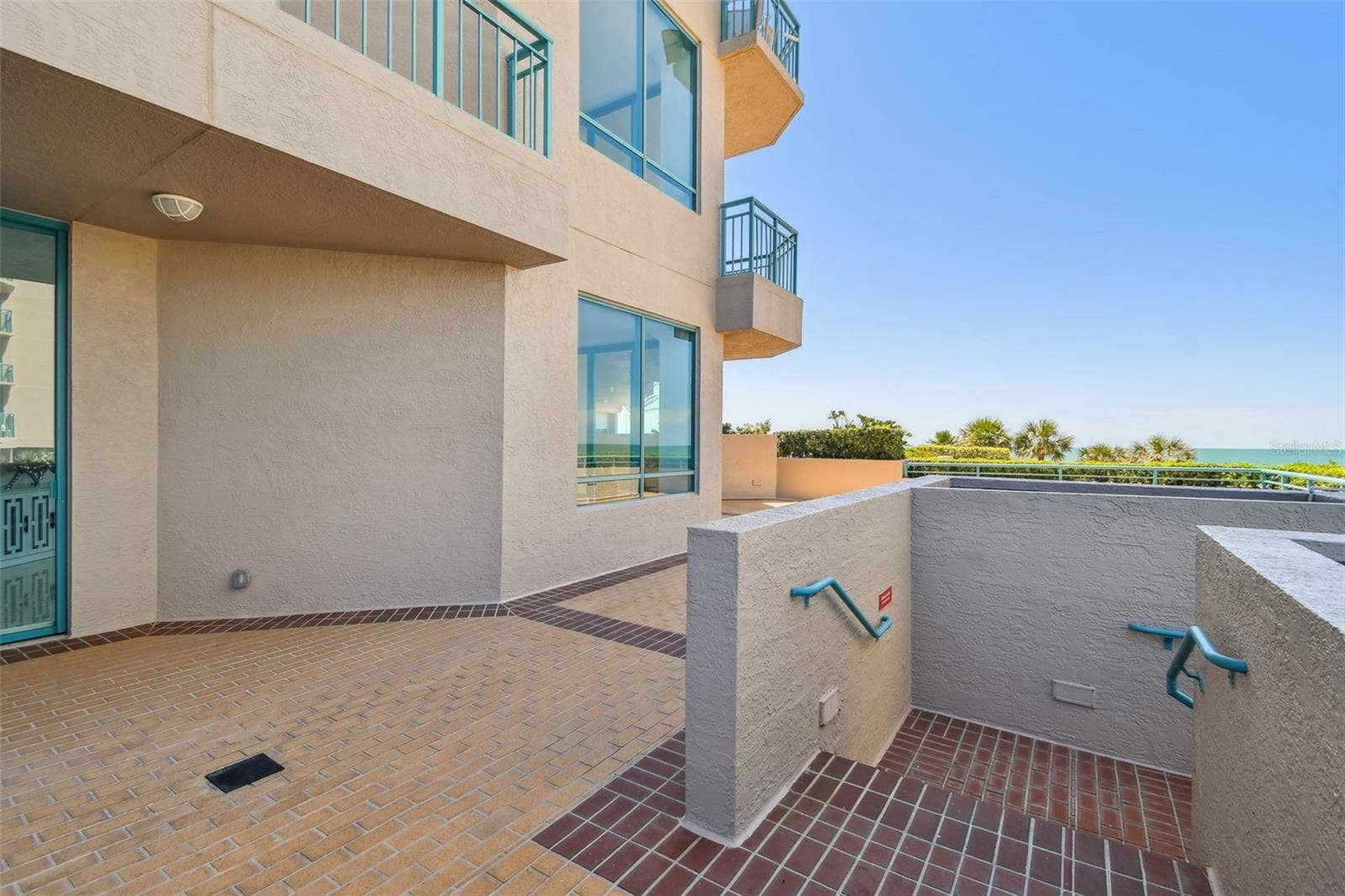 1560 GULF BOULEVARD, #306, Clearwater Beach, FL 33767 Patio-Staircase to lower level pool & patio areas.