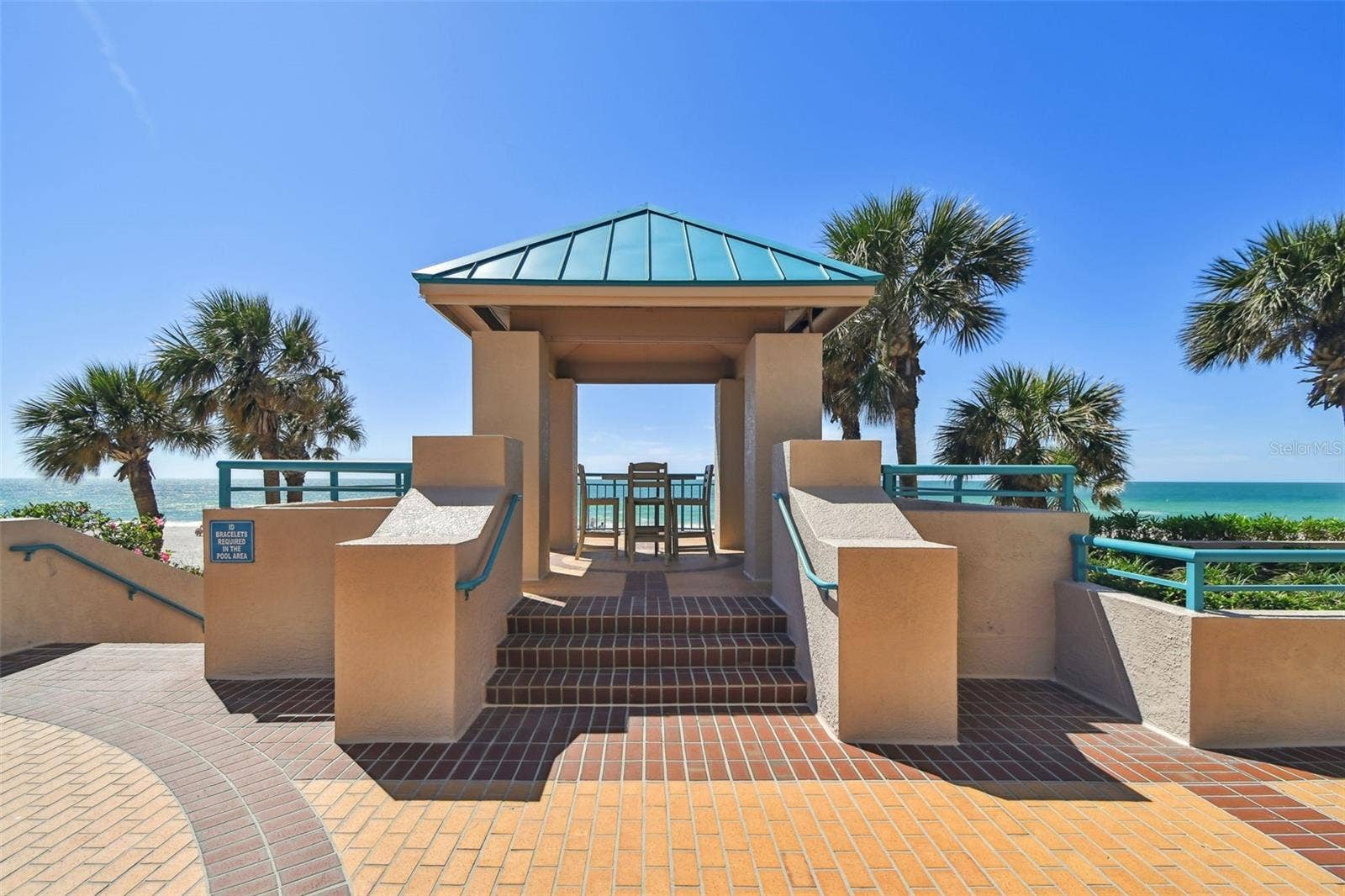 1560 GULF BOULEVARD, #306, Clearwater Beach, FL 33767 Outdoor common area patio seating area overlooking Gulf. One of many throughout the complex