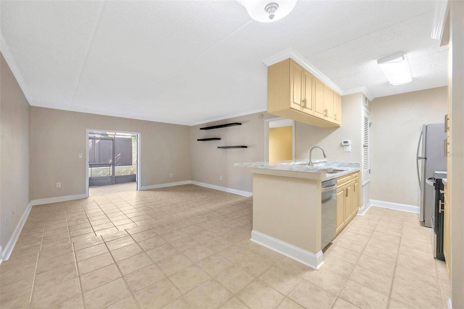 5305 SAN SEBASTIAN COURT, #127, Tampa, FL 33609 Living room and kitchen from dining