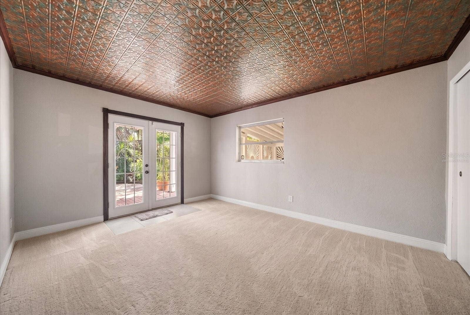 3033 82ND WAY N, St Petersburg, FL 33710 Bedroom - Virtually Staged with Carpet - French Door leading to private fenced yard