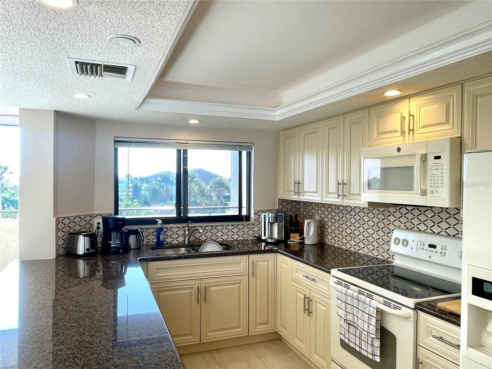 1290 GULF BOULEVARD, #302, Clearwater, FL 33767 Large kitchen with lots of storage and a view of the intracoastal