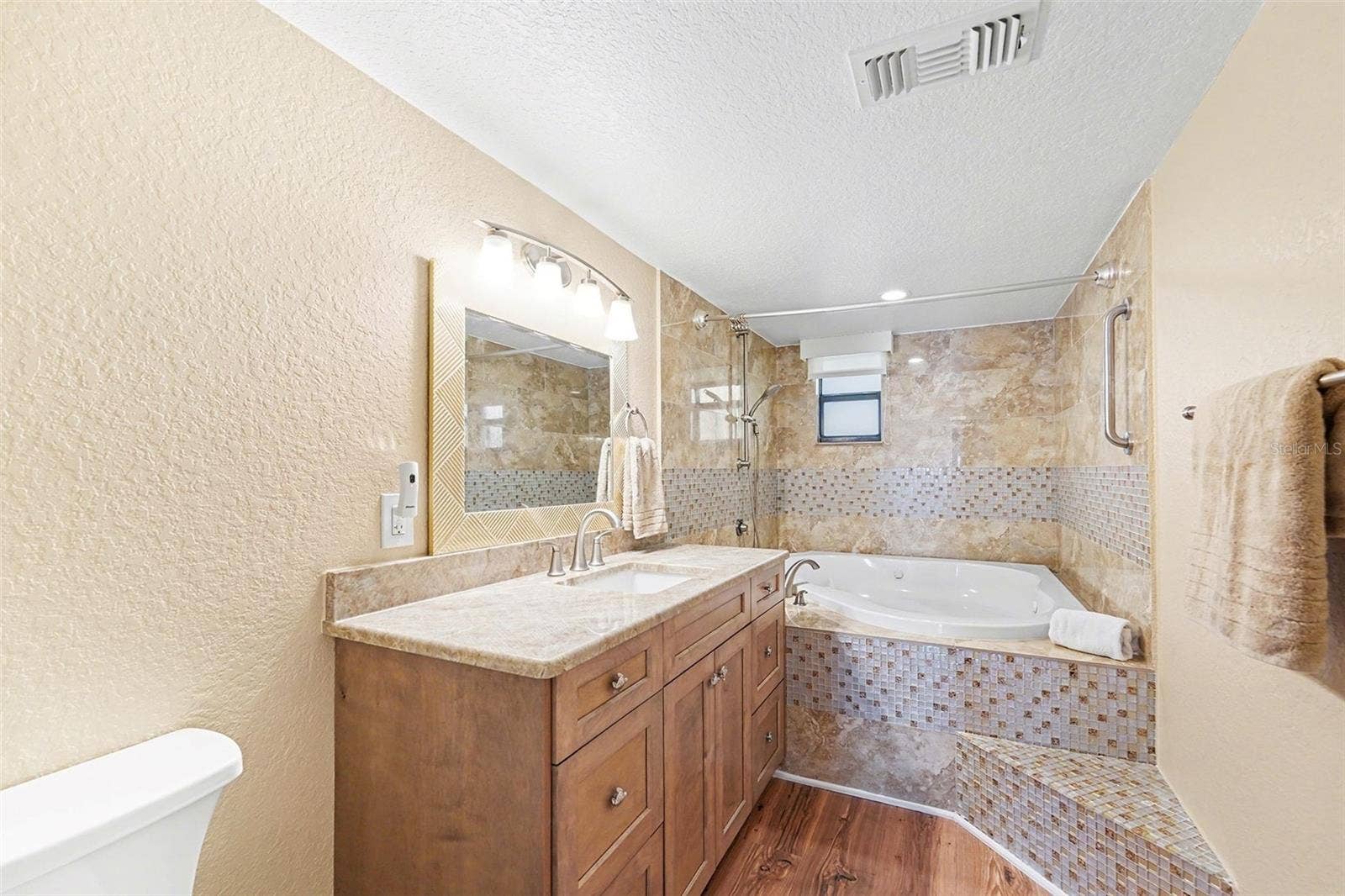19936 GULF BOULEVARD, Indian Shores, FL 33785 Primary bathroom with jetted tub, new cabinets, and countertop.