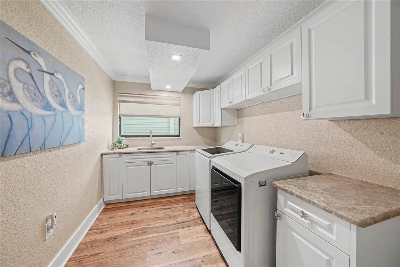 19936 GULF BOULEVARD, Indian Shores, FL 33785 First level oversized laundry room offers more storage, new cabinets, & new washer and dryer.