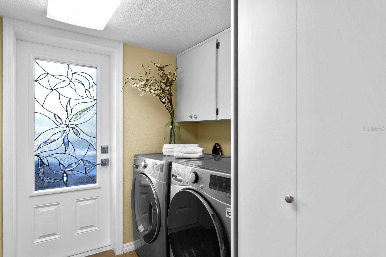 19936 GULF BOULEVARD, Indian Shores, FL 33785 Second level laundry room. Door leads to east facing balcony with partial Intracoastal views.