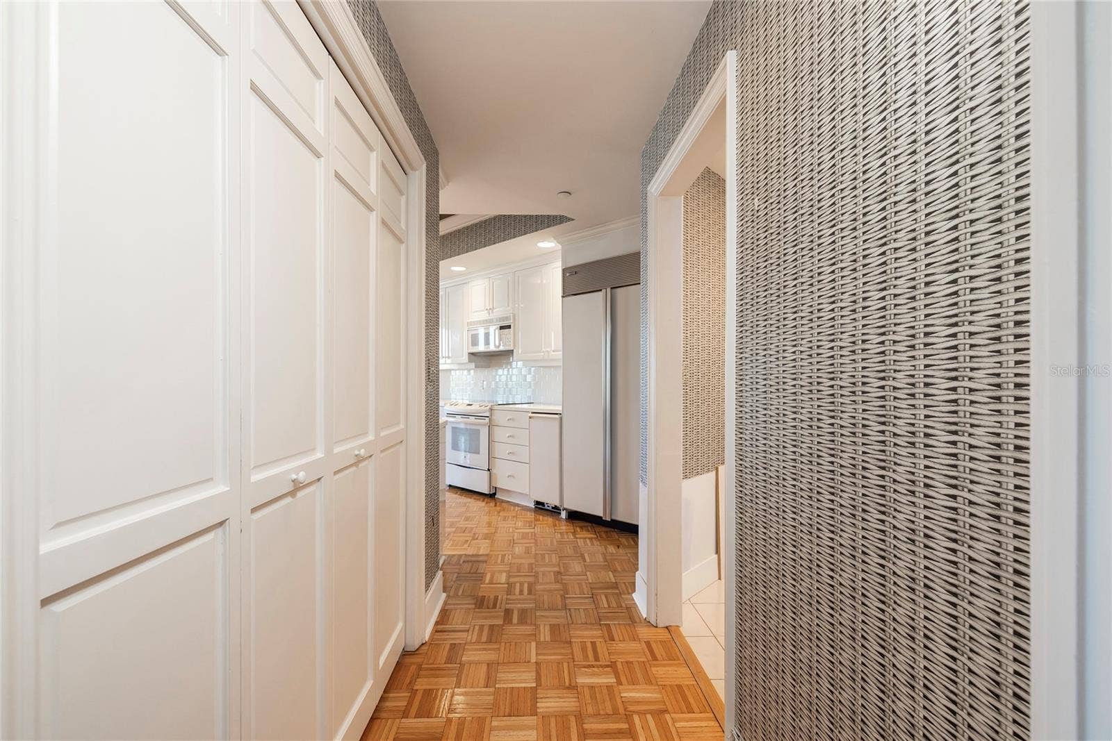 2 SEASIDE LANE, #103, Belleair, FL 33756 Kitchen Pantry on the left and Laundry Room entry on the right