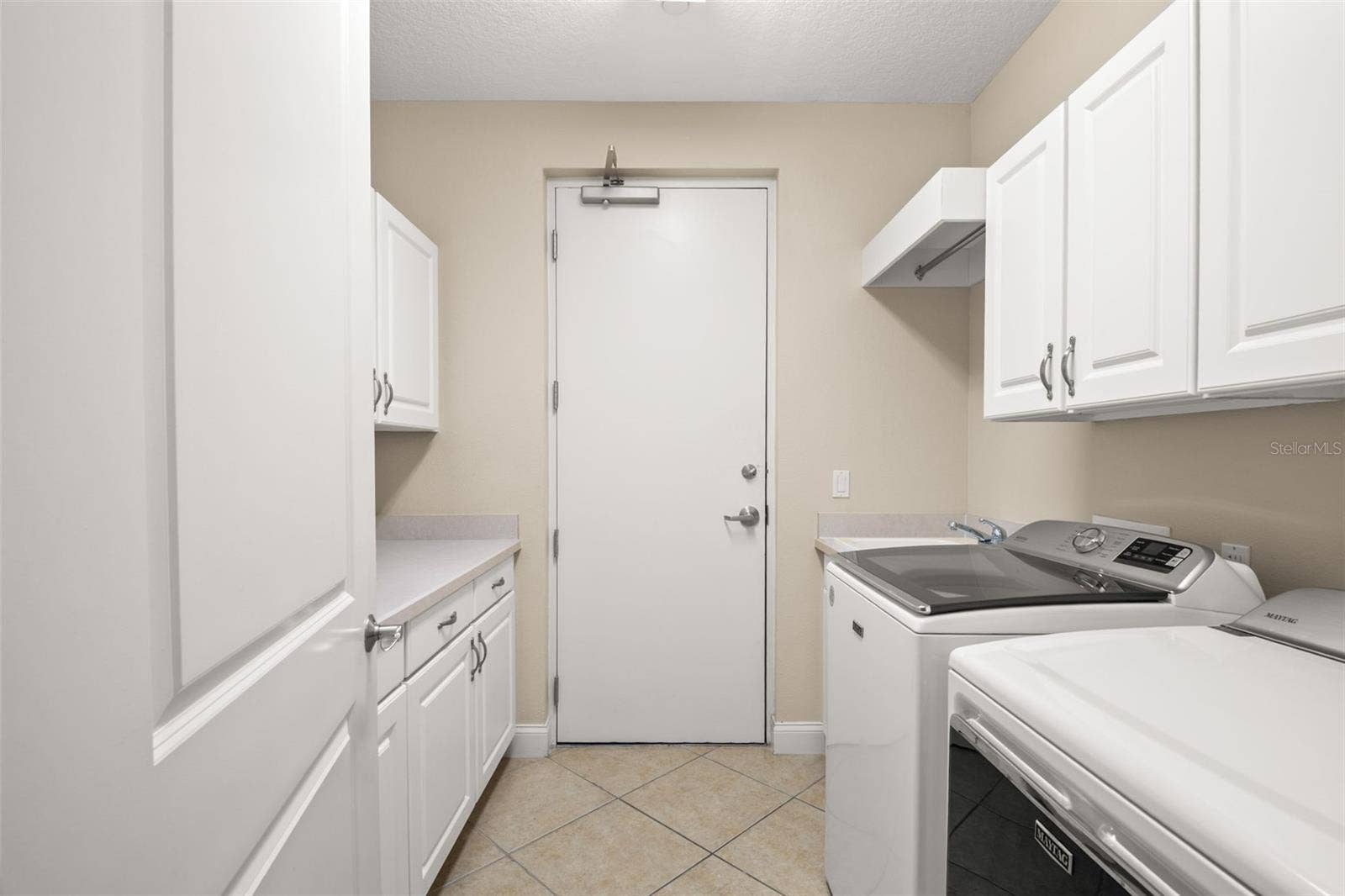 8 ACADEMY WAY S, #123, St Petersburg, FL 33711 Large utility room with lots of storage, hanging space and utility sink.