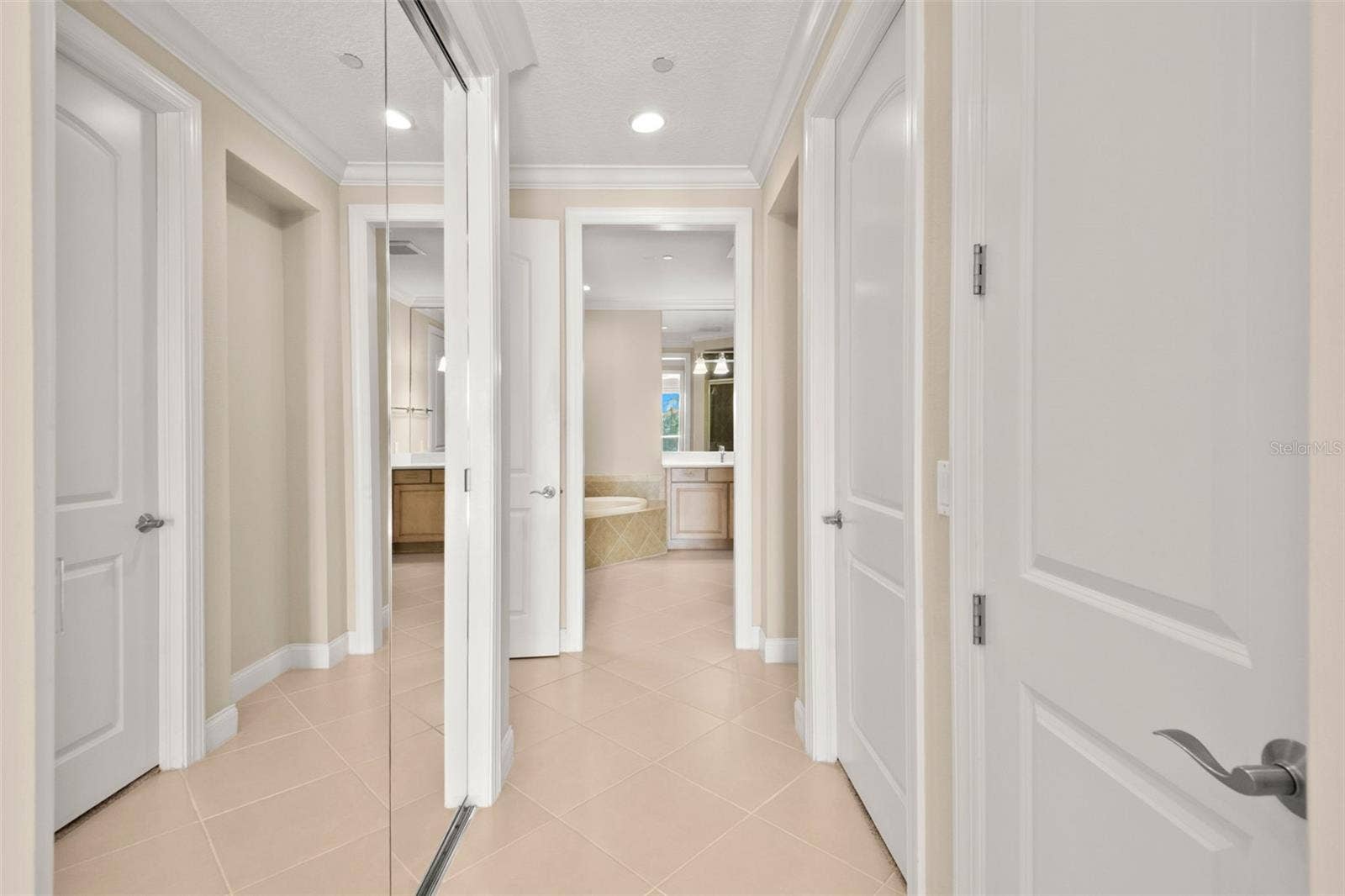 8 ACADEMY WAY S, #123, St Petersburg, FL 33711 Walking from Main Bedroom to Owner's Bath.