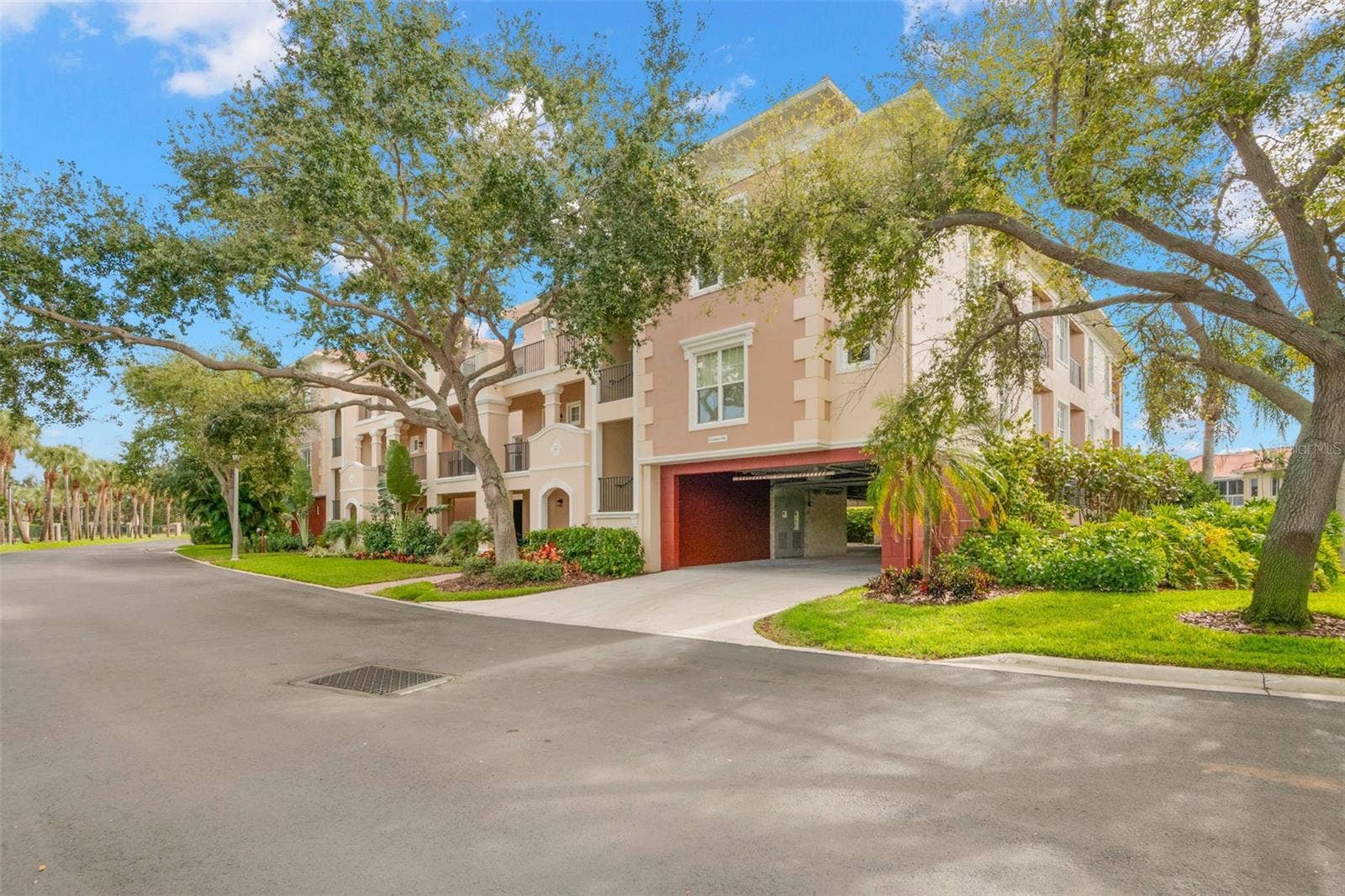 8 ACADEMY WAY S, #123, St Petersburg, FL 33711 Front of building showing garage access where each of the 8-units in the building have two, deeded parking spaces that are well protected from the sun and weather elements.