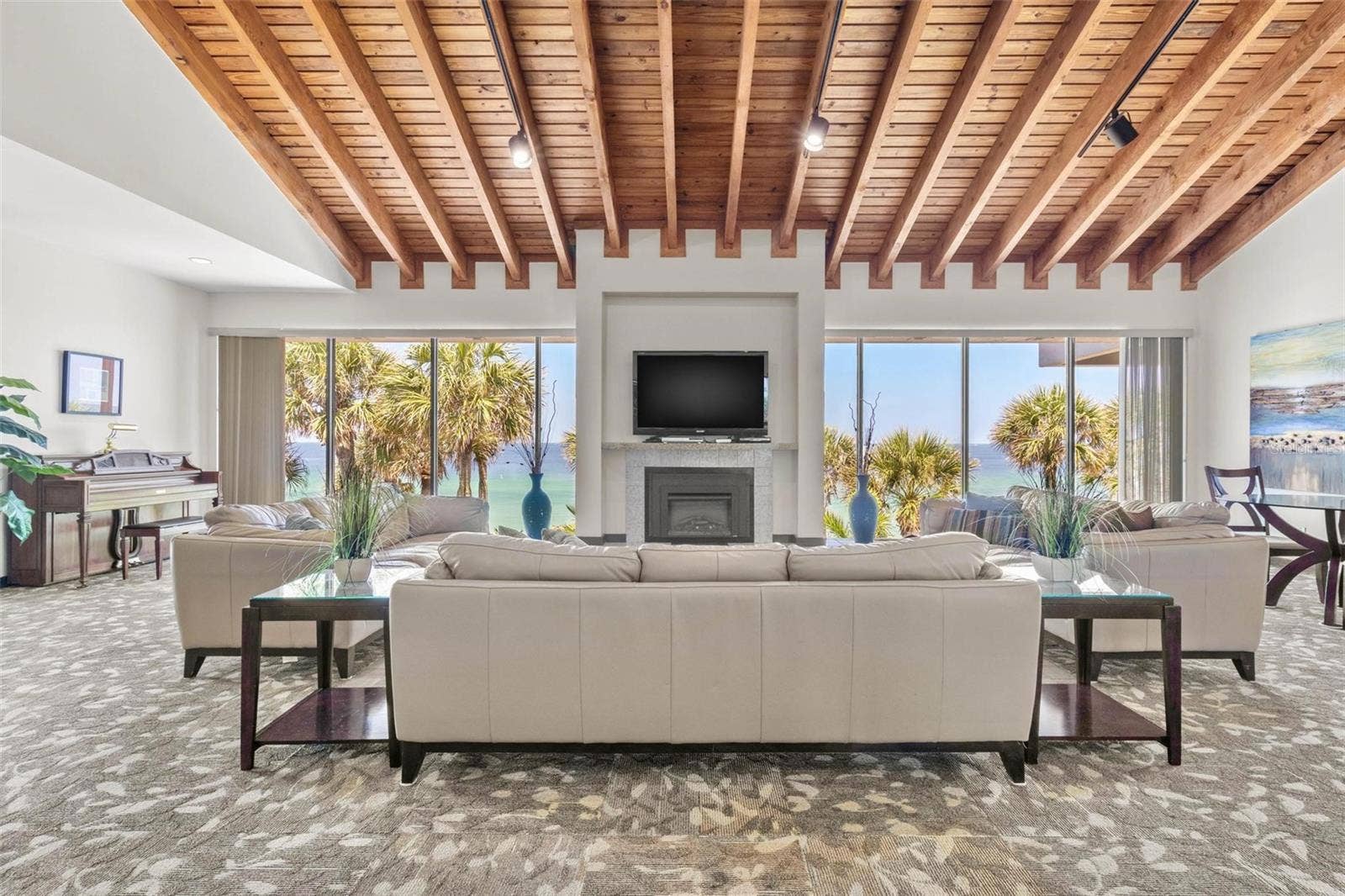 1660 GULF BOULEVARD, #607, Clearwater Beach, FL 33767 community clubhouse with fireplace, lounge area and water views