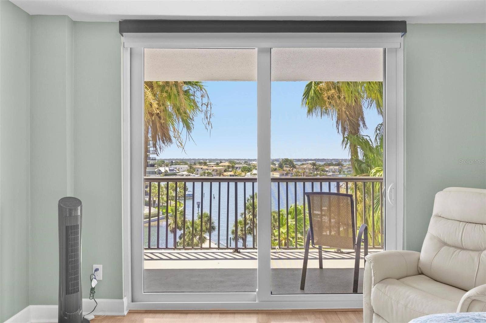 1660 GULF BOULEVARD, #607, Clearwater Beach, FL 33767 primary bedroom with bathroom en suite, water view and balcony access