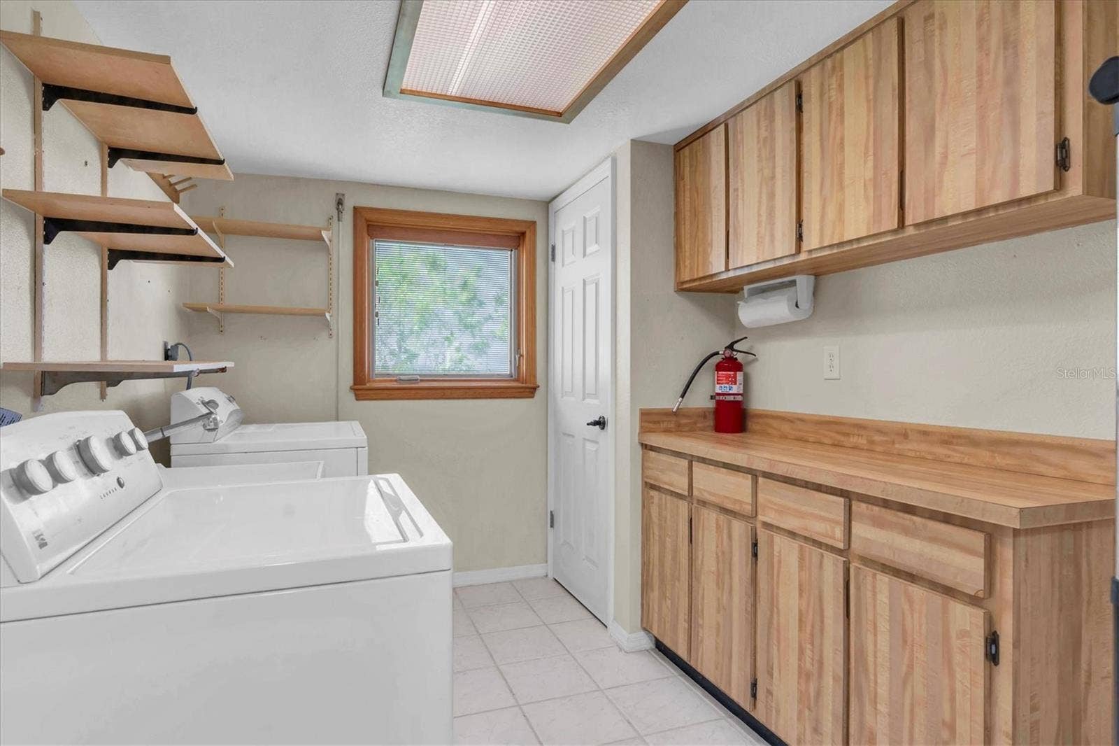 4935 62ND AVENUE S, St Petersburg, FL 33715 Laundry room with AC within the garage space