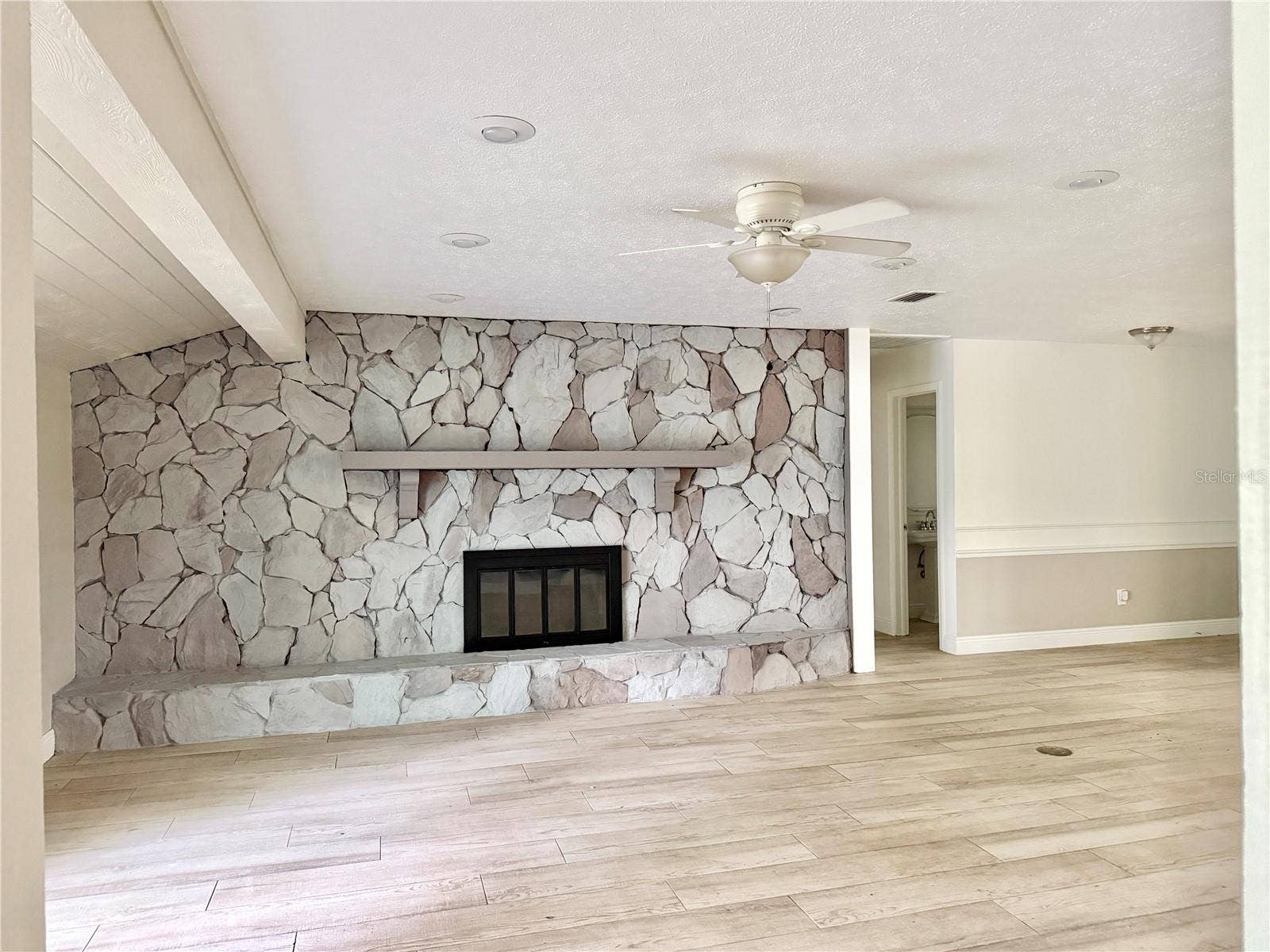 9628 DAVIS ROAD, Tampa, FL 33637 Large Living Room with Fireplace and Sliding Doors to Patio
