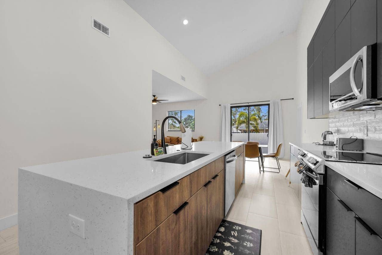 1590 S WASHINGTON AVENUE, Clearwater, FL 33756 Kitchen boasts an amazing island with a solid surface waterfall edge