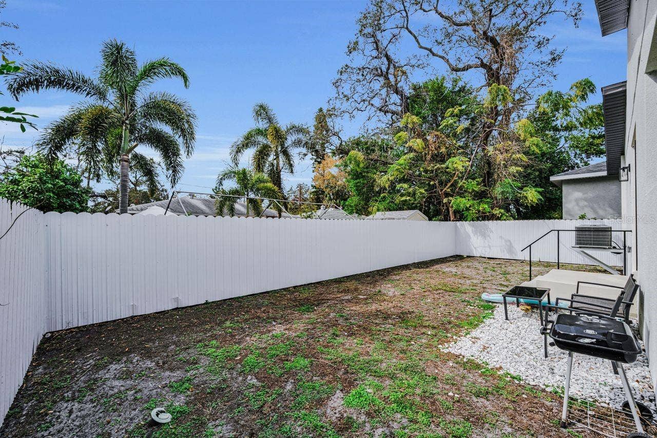 1590 S WASHINGTON AVENUE, Clearwater, FL 33756 Even the fenced yard is clean and sleek!