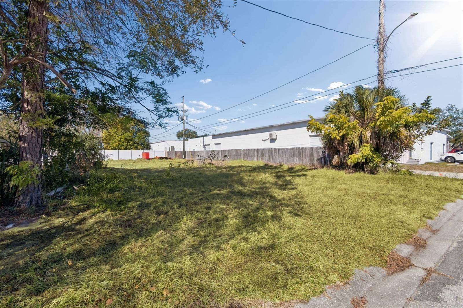 Additional street level view of the lot and surrounding properties.