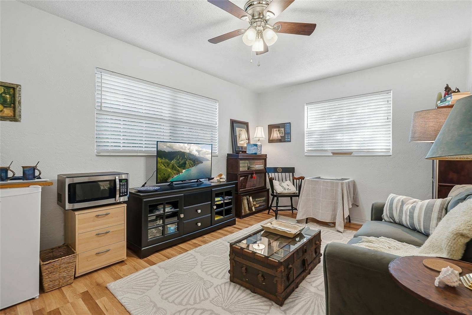 1890 62ND AVENUE S, St Petersburg, FL 33712 Windows on two walls brighten this versatile bedroom, currently arranged as a relaxed sitting room with space to read, work, or unwind.