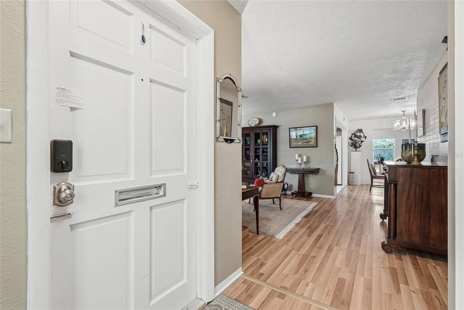 1890 62ND AVENUE S, St Petersburg, FL 33712 An inviting entry opens to comfortable living spaces, with warm wood flooring connecting the living and dining areas.