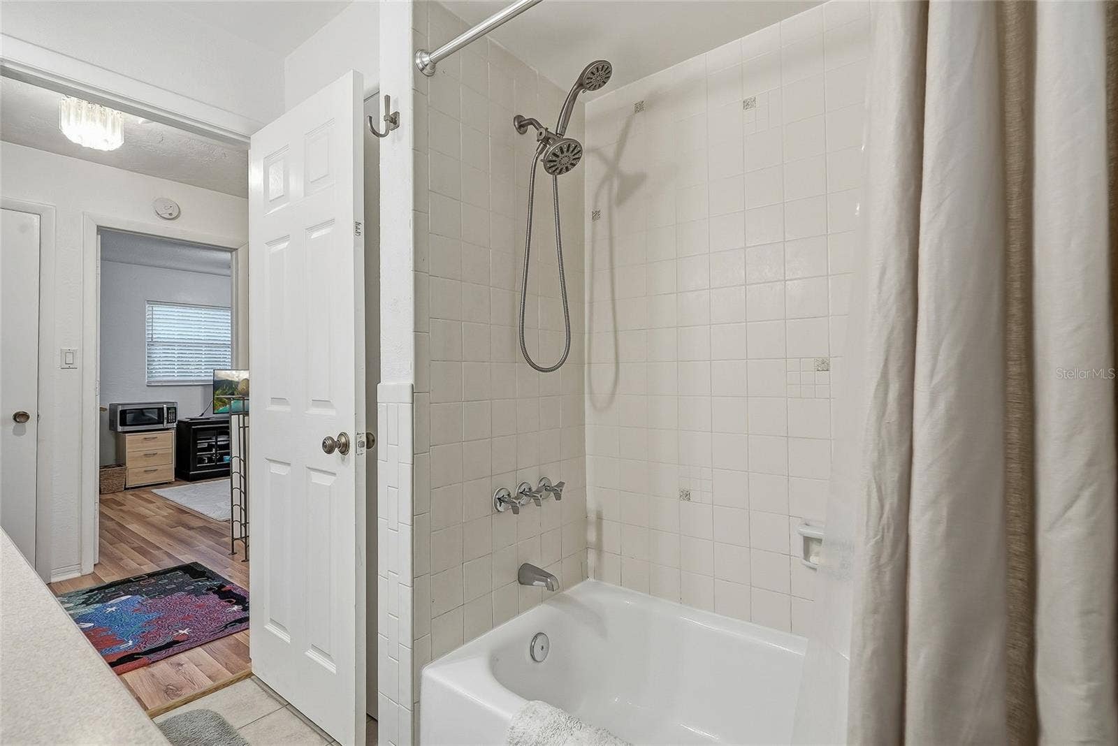 1890 62ND AVENUE S, St Petersburg, FL 33712 Enjoy the flexibility of a full tub and shower combination, finished with classic white tile and a handheld showerhead.