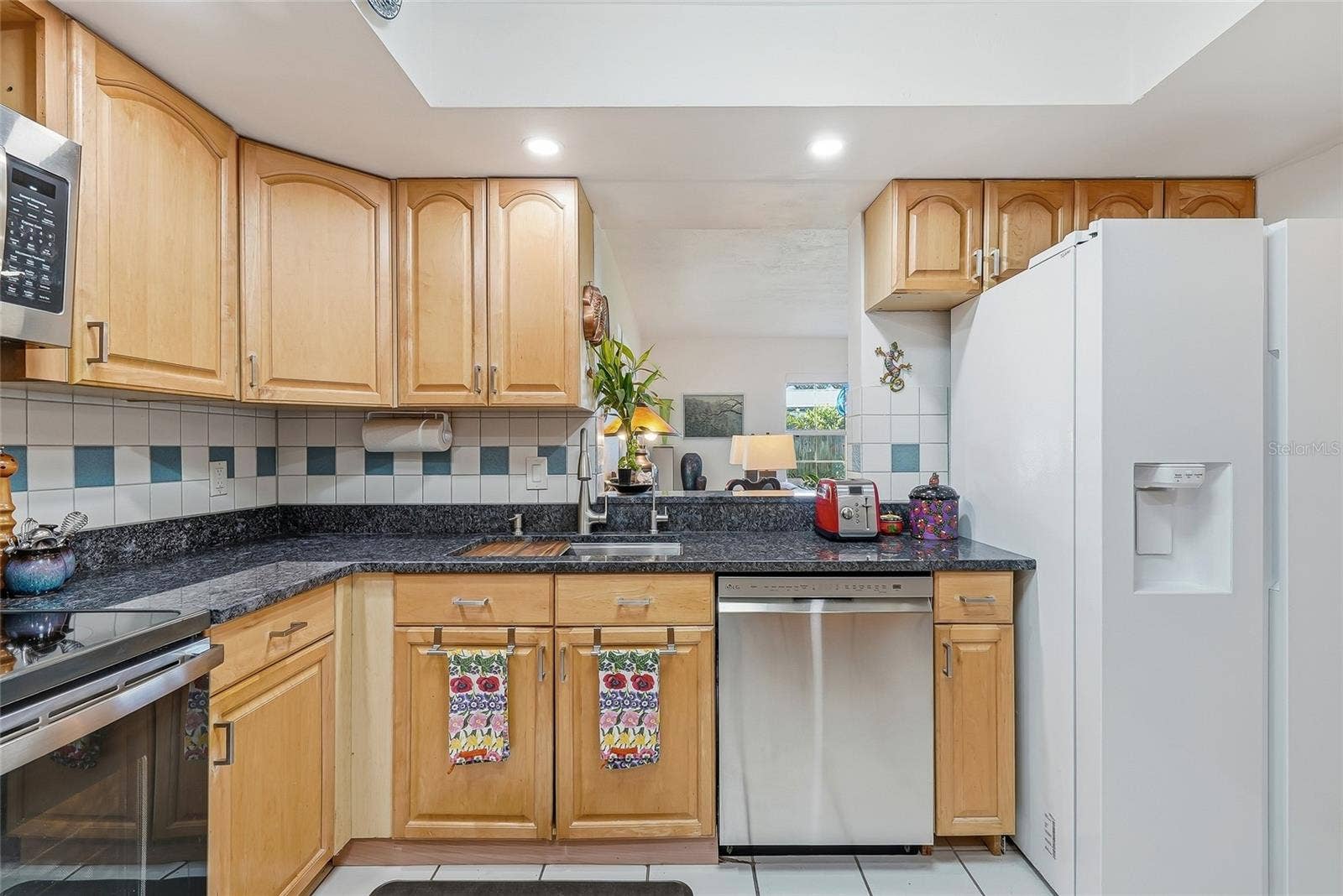 1890 62ND AVENUE S, St Petersburg, FL 33712 Everything within reach, with wraparound counters, plentiful cabinet storage, and a convenient pass-through connecting the kitchen to the family room.