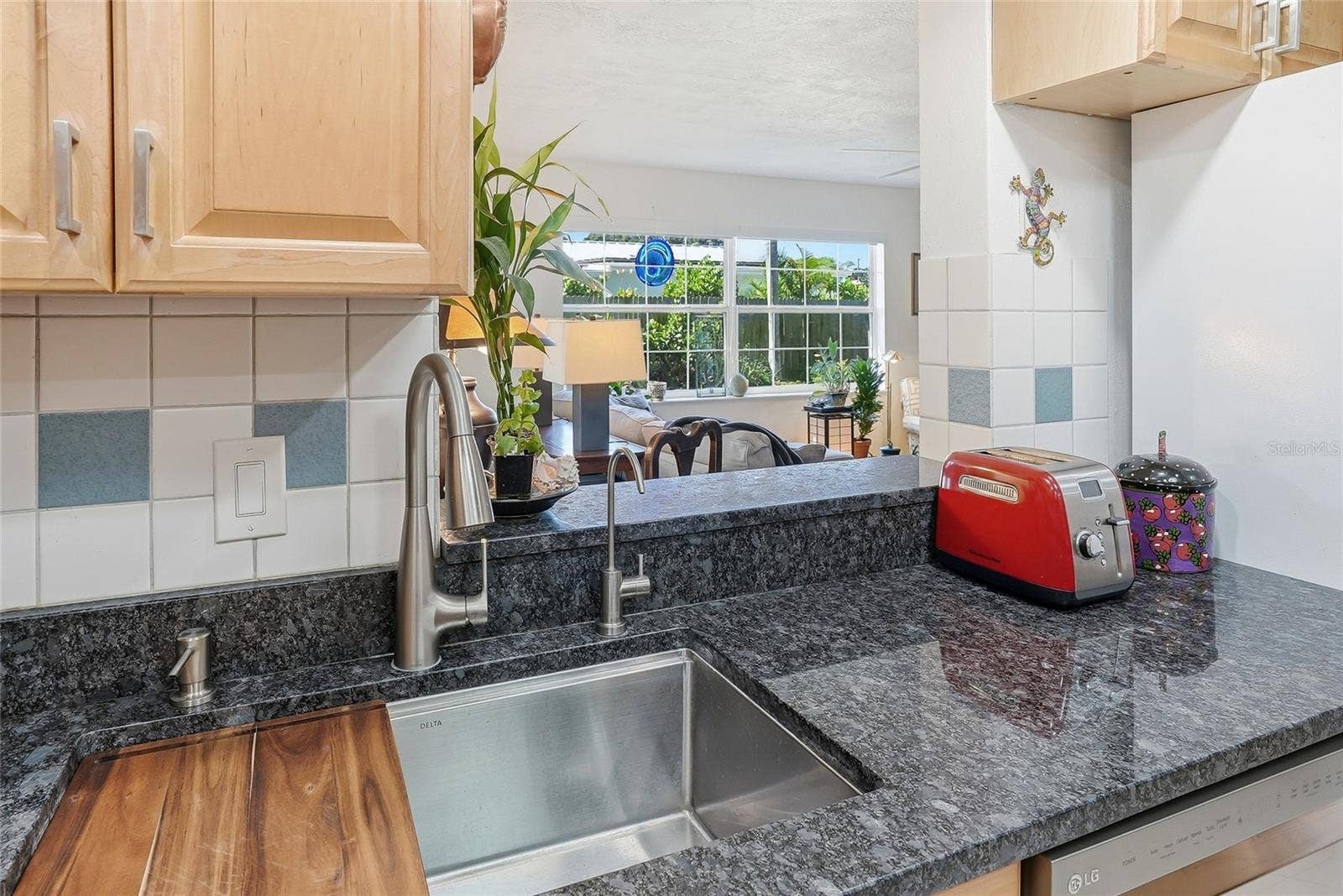 1890 62ND AVENUE S, St Petersburg, FL 33712 Stay part of the conversation while preparing meals, with an open pass-through overlooking the bright family room and its leafy backyard views.