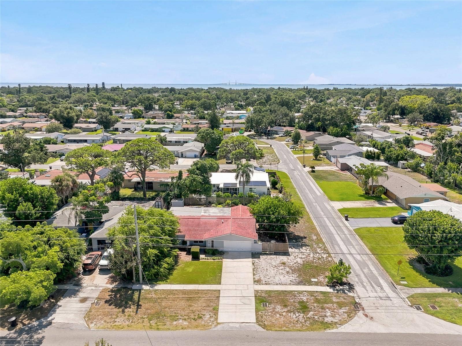1890 62ND AVENUE S, St Petersburg, FL 33712 See the corner setting from above, with a broad driveway, mature trees, and generous outdoor space surrounding the home.