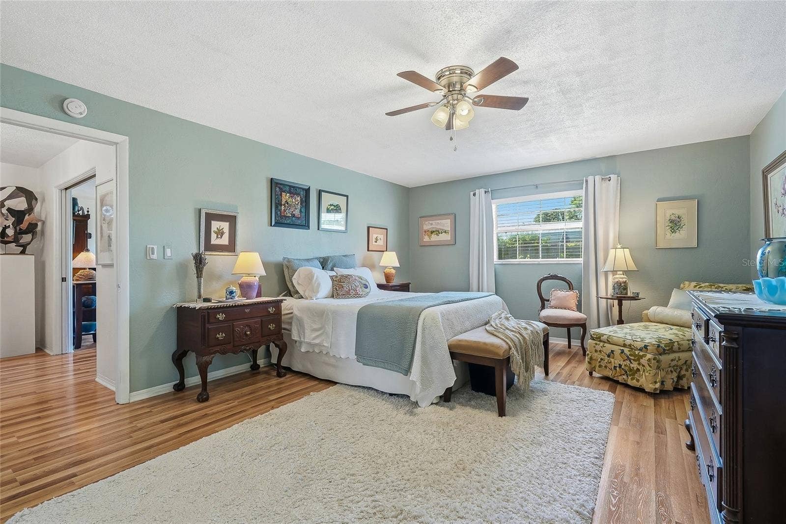 1890 62ND AVENUE S, St Petersburg, FL 33712 More than a place to sleep, this spacious primary bedroom offers room for a cozy reading corner beside the window.