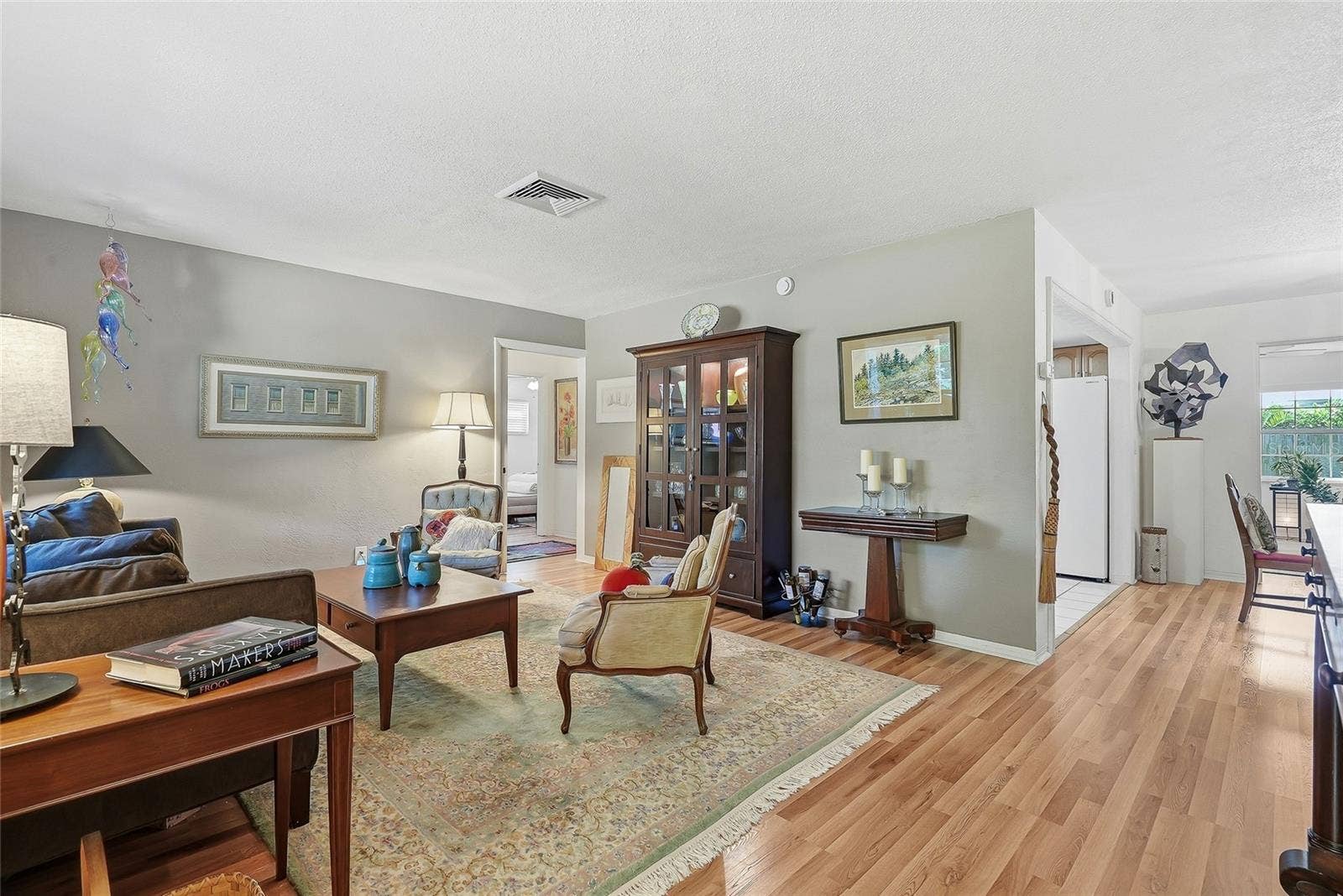 1890 62ND AVENUE S, St Petersburg, FL 33712 Room to gather and unwind. The spacious living room offers flexible furniture arrangements and easy access to the kitchen, dining area and guest bedrooms, separated by a working pocket door.