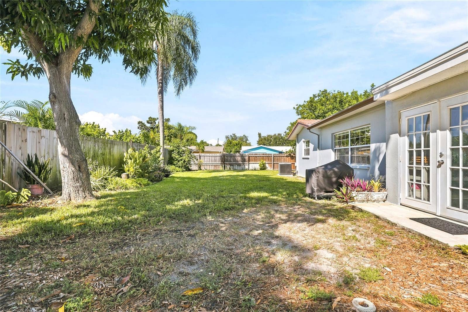 1890 62ND AVENUE S, St Petersburg, FL 33712 Step through the Florida rooms French doors into a spacious backyard ready for afternoon barbecues and relaxed outdoor entertaining.