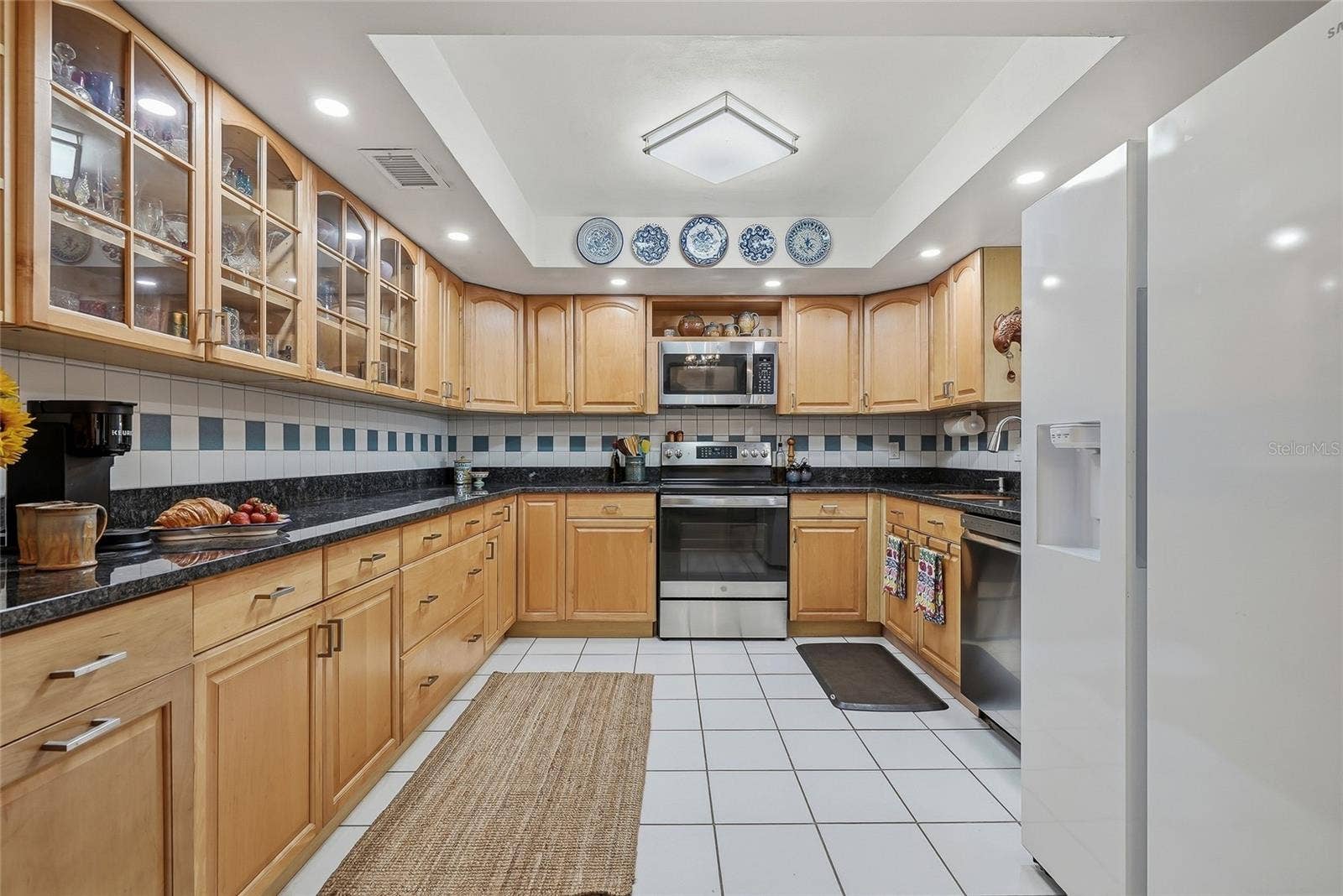 1890 62ND AVENUE S, St Petersburg, FL 33712 Spread out and create in a kitchen featuring generous counter space, abundant cabinetry, and glass-front cabinets to showcase your favorite pieces.