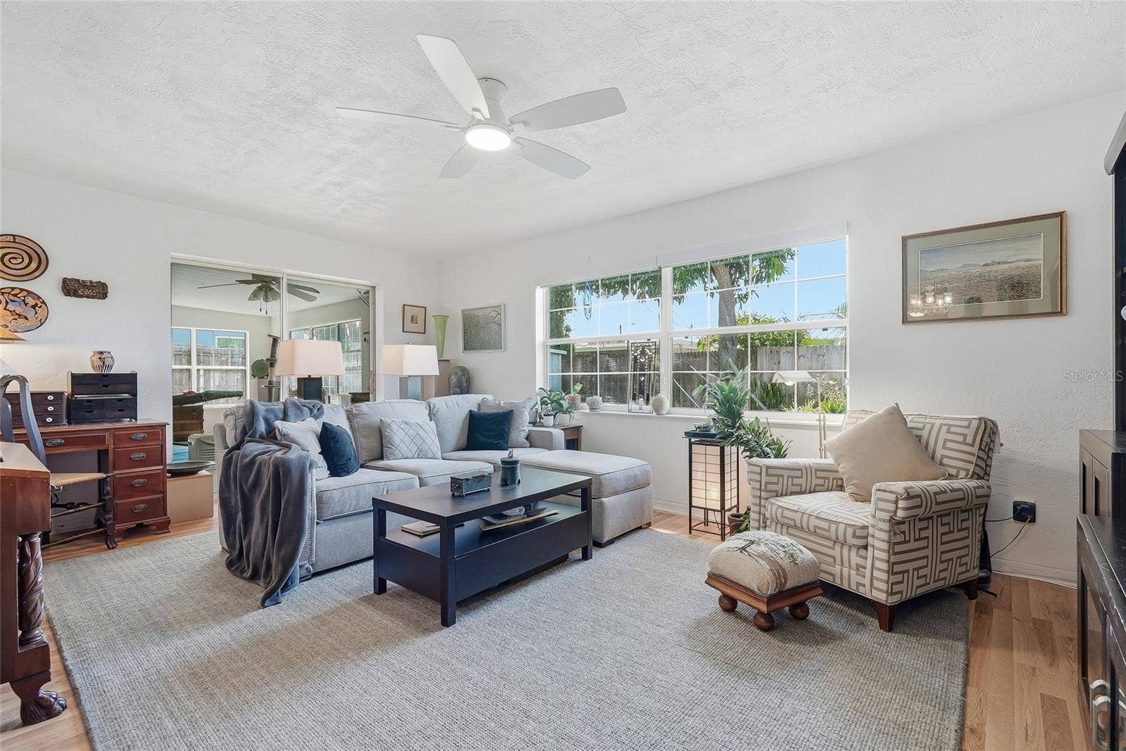 1890 62ND AVENUE S, St Petersburg, FL 33712 Sunlight pours through a wide window in the family room, while sliding glass doors connect this comfortable gathering space to the enclosed Florida room.