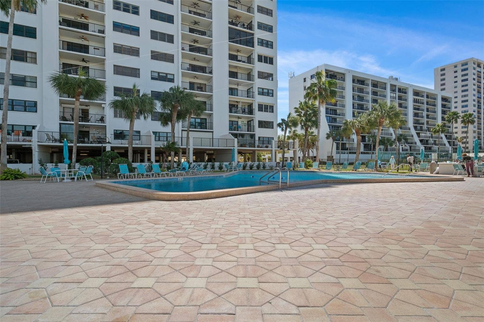 1230 GULF BOULEVARD, #303, Clearwater Beach, FL 33767 Spacious pool deck with plenty of table, chairs and chaise lounges around the refreshing pool!