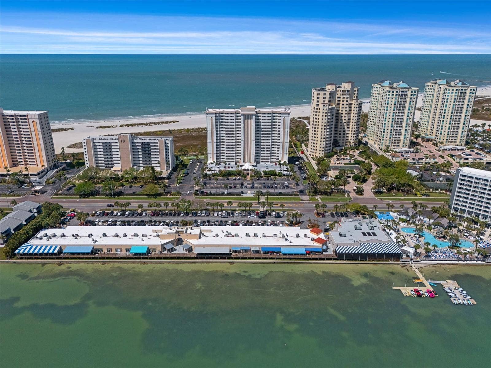 1230 GULF BOULEVARD, #303, Clearwater Beach, FL 33767 Aerial view of Shopping Center with restaurants (Columbia, Backwaters etc) with waterfront dining that is just across the street from the community! A Marriott hotel offers extra accommodations for visiting guests plus jet ski and paddleboard rentals!