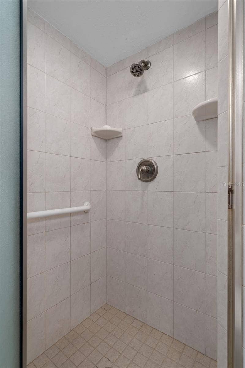 1230 GULF BOULEVARD, #303, Clearwater Beach, FL 33767 Guest bathroom features a walk-in shower
