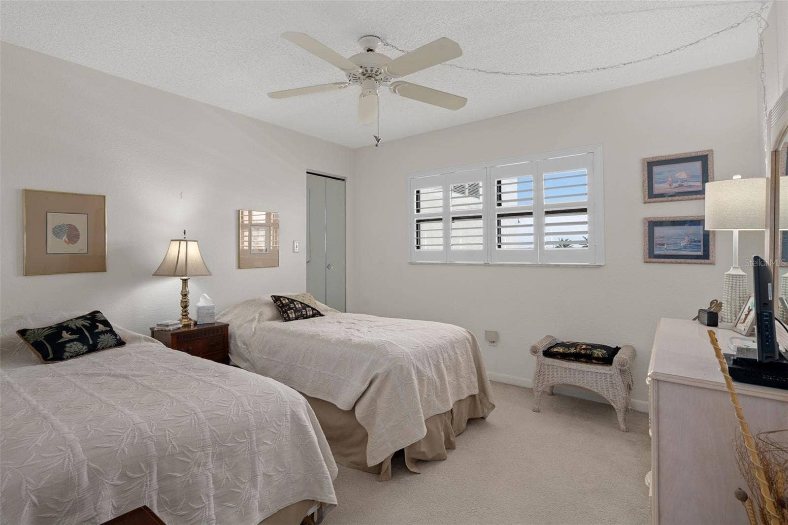 1230 GULF BOULEVARD, #303, Clearwater Beach, FL 33767 Bedroom 2 at front of unit also features a walk-in closet and Plantation shutters