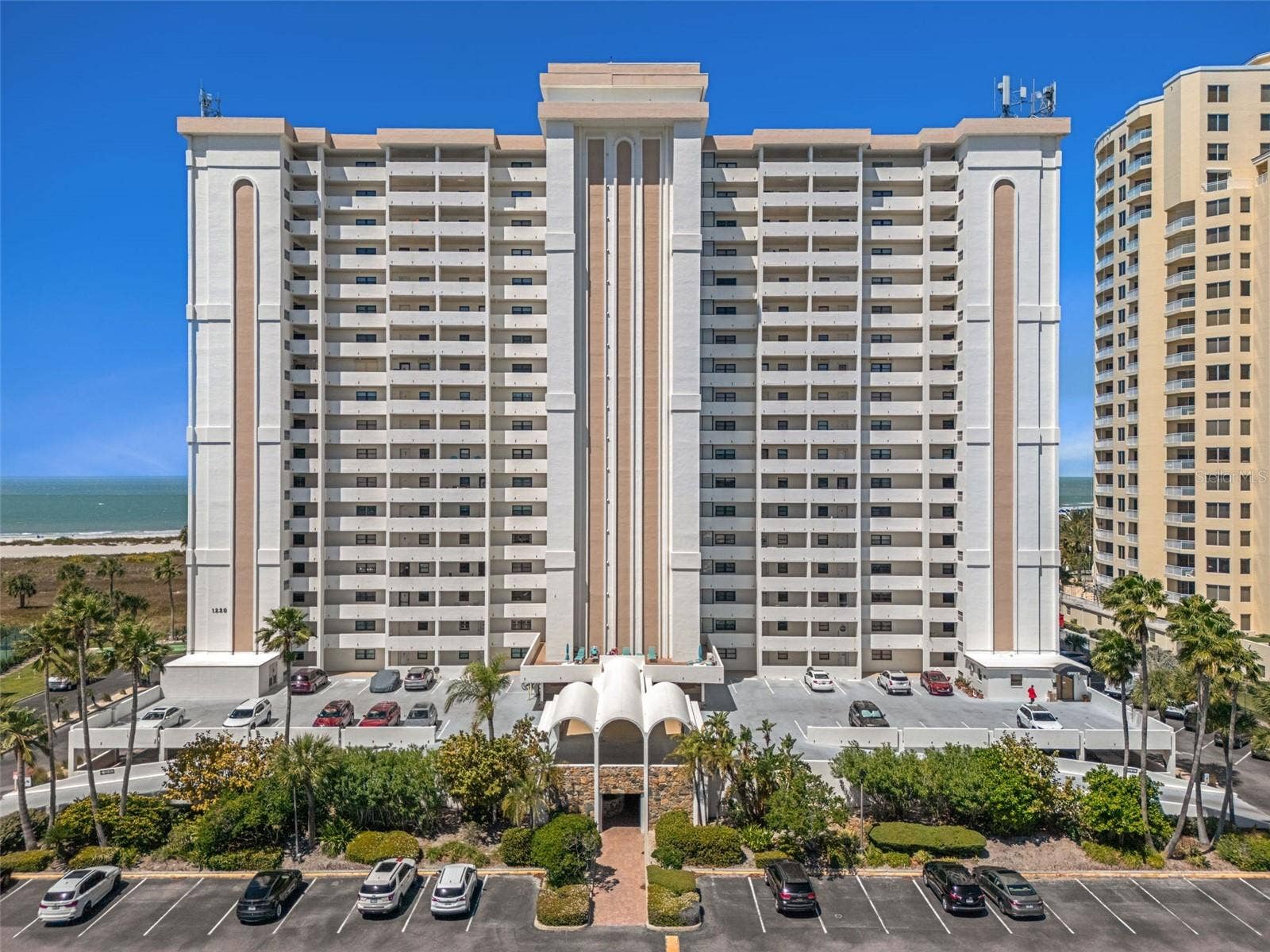 1230 GULF BOULEVARD, #303, Clearwater Beach, FL 33767 Landmark Tower One features a guarded gate ...Once in to parking area, access to the building is either through the lower lot & breezeway, the parking garage under building or the upper deck covered area. Parking spot #124 in front to the left of lower level breezeway.