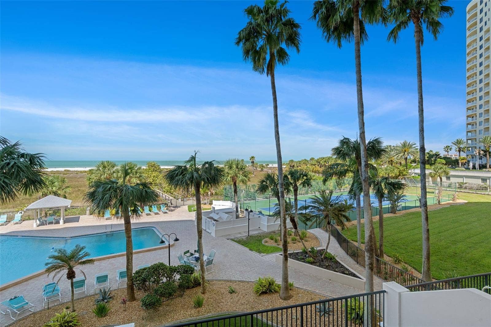 1230 GULF BOULEVARD, #303, Clearwater Beach, FL 33767 View from patio of 303. Notice the beautifully maintained grounds and amenities