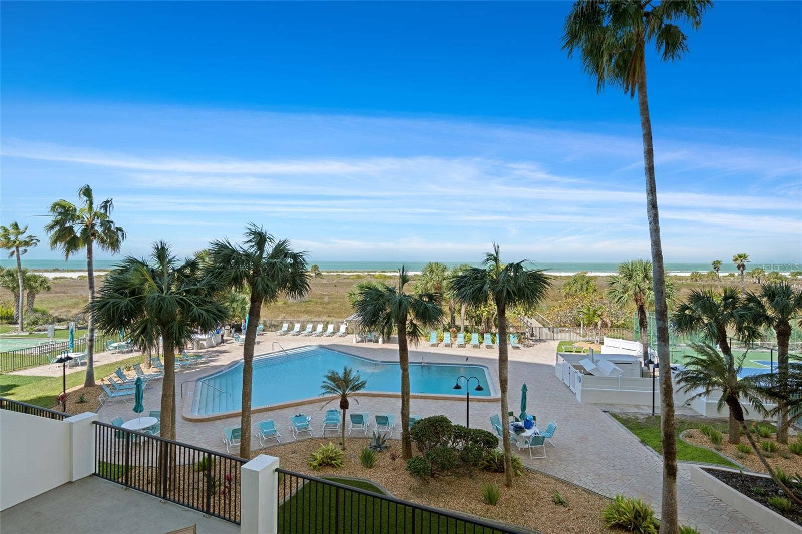 1230 GULF BOULEVARD, #303, Clearwater Beach, FL 33767 View from patio of 303 of the refreshing pool, spacious deck area & beautiful beach!