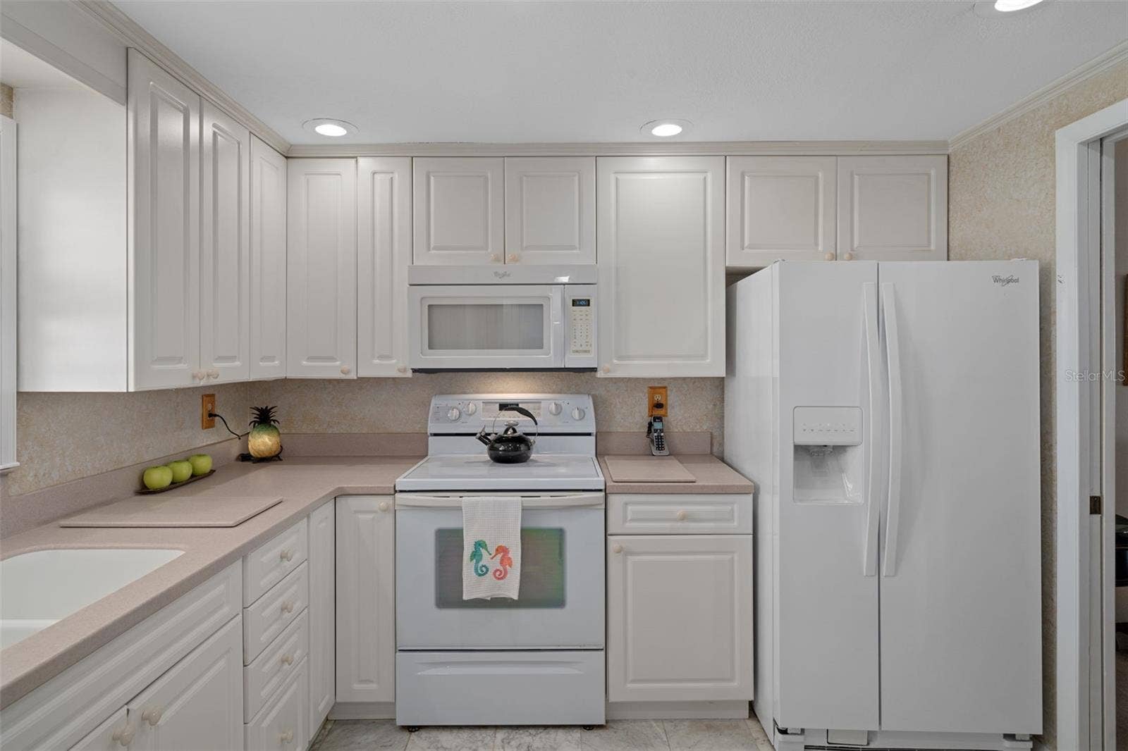 1230 GULF BOULEVARD, #303, Clearwater Beach, FL 33767 A roomy & bright kitchen with plenty of storage!