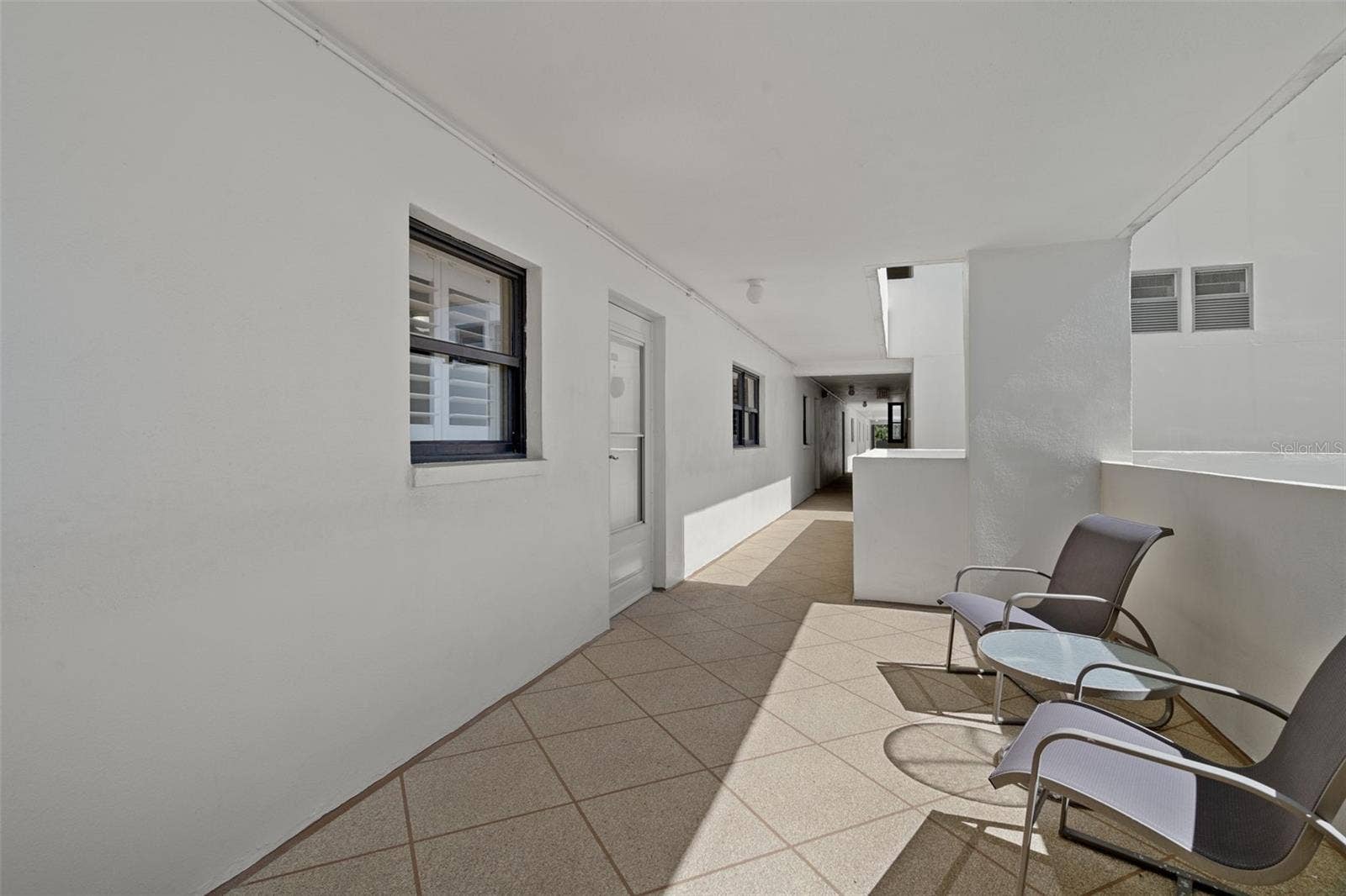 1230 GULF BOULEVARD, #303, Clearwater Beach, FL 33767 Patio/sitting area outside of unit 303