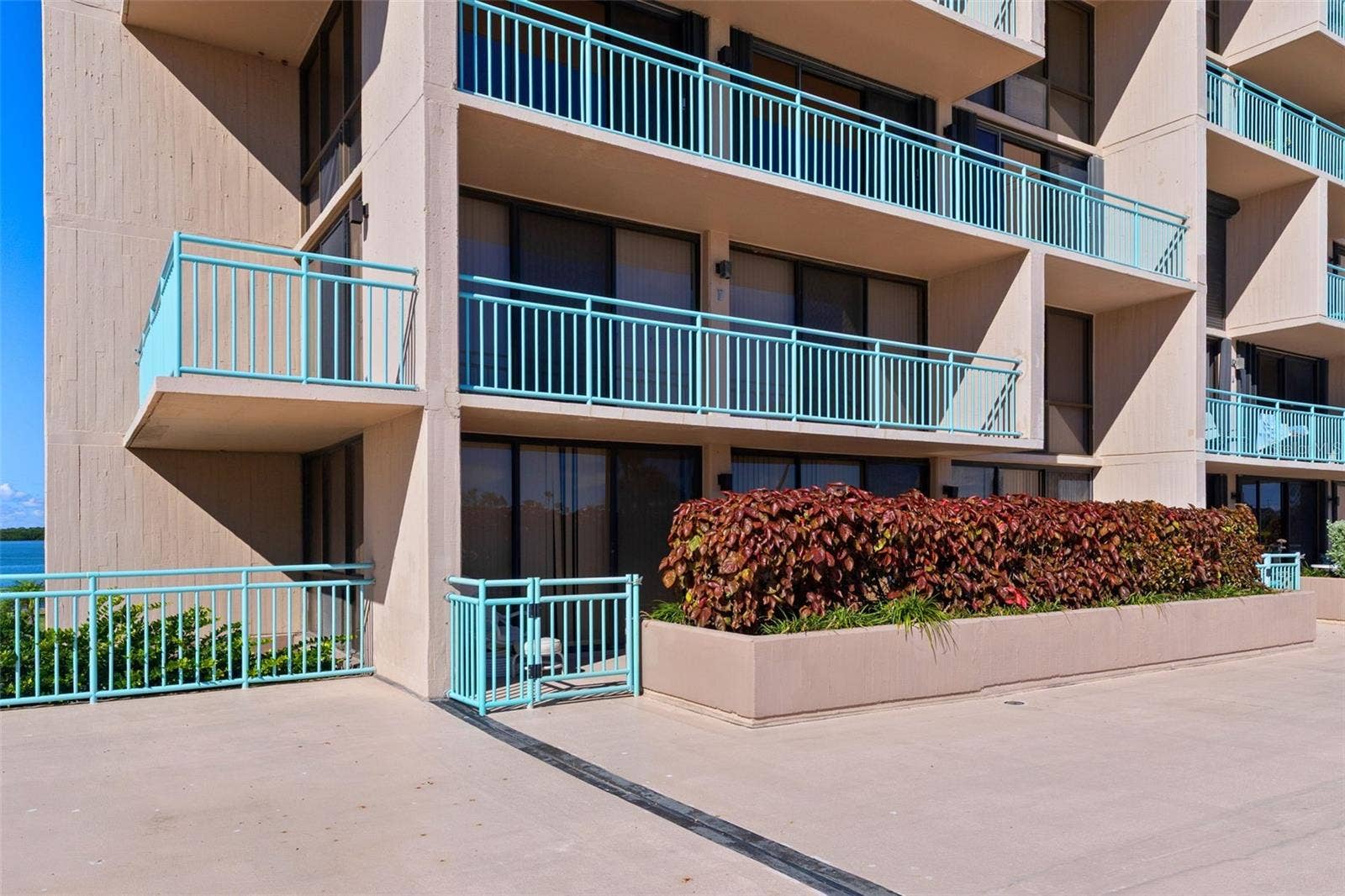 1 KEY CAPRI, #102E, Treasure Island, FL 33706 your private Terrace is behind the hedge - offering IMMEDIATE access to Tiki Hut and POOL / Spa